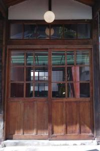 a wooden entry door to a building at 台中包棟百年日式老宅 請先致電詢問日期 in Taichung