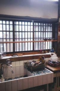 a kitchen with windows and a counter with a sink at 台中包棟百年日式老宅 請先致電詢問日期 in Taichung