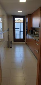 a large kitchen with a view of a balcony at Habitacion con Piscina y Sauna in Sant Cugat del Vallès