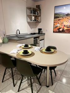 a table in a kitchen with two plates on it at La Vita hospedaria studio verde in Nova Veneza