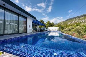 a swimming pool in front of a house at Villa Serengeti / Kalkan in Kaş