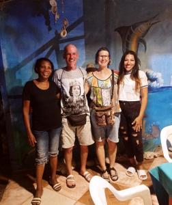 a group of people standing in front of a painting at HOSTAL BELLEZA TROPICAL in Moñitos