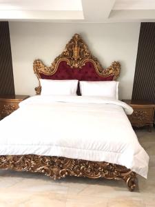 a bed with an ornate headboard in a bedroom at Burj A Zafar in Murree