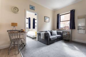 a living room with a couch and a chair at Promenade Apartments Maldon in Maldon