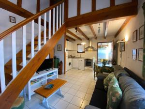 a living room with a couch and a staircase at Villa Capbreton, 4 pièces, 6 personnes - FR-1-413-106 in Capbreton