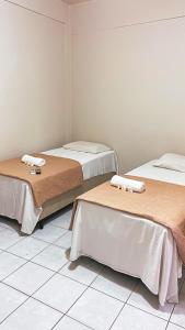 a room with two beds with towels on them at SÃO CRISTOVÃO HOTEL in São Luís