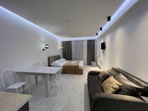 a living room with a couch and a table at Hotel Peak in Gudauri