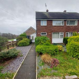 a brick house with a walkway in front of it at The Rose in Greasbrough