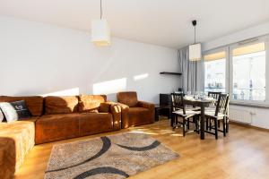 a living room with a couch and a table at ApartamentyGdansk EU Marina Primore in Gdańsk