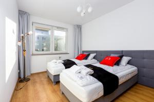 a bedroom with two beds and a window at ApartamentyGdansk EU Marina Primore in Gdańsk