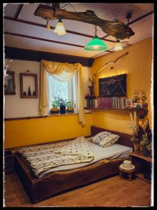 a bedroom with a large bed in a yellow room at Cinderella Guitars 