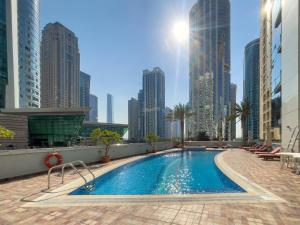 a swimming pool in a city with tall buildings at Luxe Living in our Exquisite 1 Bedroom Apartment in Dubai