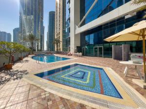 a mosaic pool in the middle of a building at Luxe Living in our Exquisite 1 Bedroom Apartment in Dubai