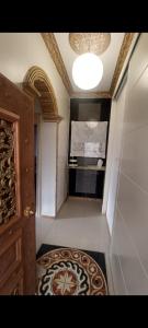 a hallway with a door and a television in a room at الينبوع الأخضر in Al Madinah