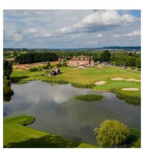 an aerial view of a golf course with a lake at Parlors Hall Hotel in Bridgnorth