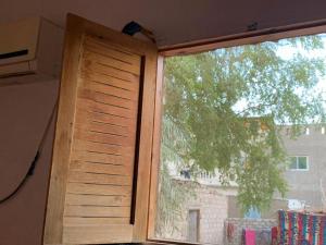ventana en una habitación con persianas de madera en AMFIBIANHouse, en Dahab