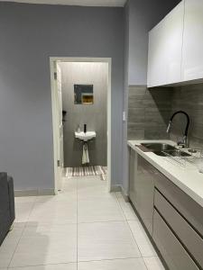 a white kitchen with a sink and a sink at Ongwe Complex - Holiday Apartment in Swakopmund