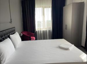 a bedroom with a large bed with a white bedspread at RESPİRO PARK HOTEL in Buyukcekmece