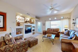 a living room with two couches and a tv at Rancho Vistoso #256 in Tortolita