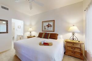 a bedroom with a large white bed and two lamps at Rancho Vistoso #256 in Tortolita +20 photos