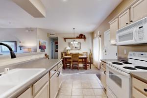 a kitchen with white appliances and a dining room at Rancho Vistoso #256 in Tortolita