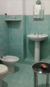 a bathroom with a sink and a toilet at La Villa di Minerva in Agrigento