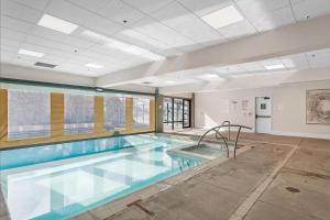 a large swimming pool in a building at Slope-Side Serenity Ski-In Ski-Out Gem with Pool in Park City