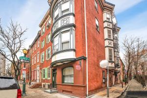 a red brick building on the corner of a street at Private Remodeled Studio In Vibrant Center City in Philadelphia