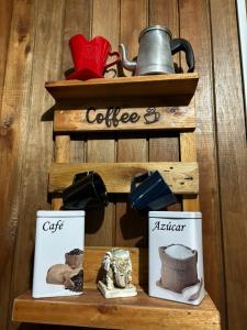 a wooden shelf with pictures of coffee and a kettle at CABANAS BELVEDERE- SERRA DO RIO Do RASTRO in Lauro Müller
