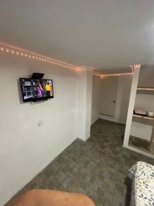 a living room with a tv on the wall at Laguna 11 in Tampico