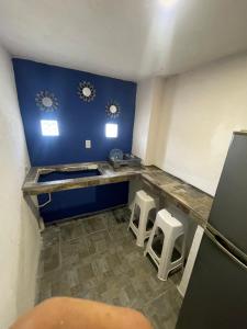 a kitchen with a counter and stools in a room at Laguna 11 in Tampico
