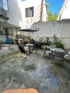 a patio with a table and chairs and an umbrella at Laguna 11 in Tampico +1 photo