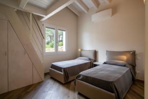 Postel nebo postele na pokoji v ubytování Villa Margidore