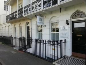 a building with a black door on a street at Churchill Brighton in Brighton & Hove