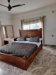 a bedroom with a large wooden bed and a window at The Beach House in Chennai +93 photos