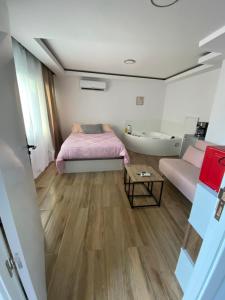 a bedroom with a bed and a tub and a sink at PLAYA POSTIGUET in Alicante