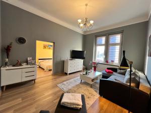 a living room with a couch and a tv at Wolności 21 Jelenia Góra in Jelenia Góra