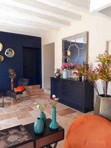 a living room with two vases on a table at Domaine de la Limetiere in Neuvy-le-Roi