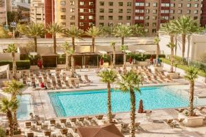 an overhead view of a pool with chairs and palm trees at Strip View Suites - No Resort Fee ! in Las Vegas