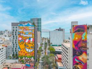 a city with tall buildings with paintings on them at Pullman Lima Miraflores in Lima +148 photos
