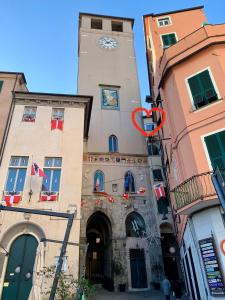 a tall building with a clock tower on it at Via Pia 29-7 in Savona