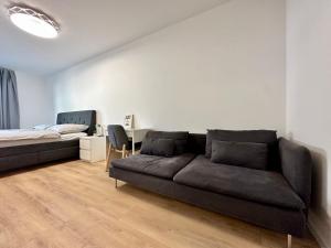 a living room with a couch and a bed at Vivien Modern City in Brno
