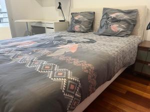 a bed with a bedspread with a woman on it at Wilson New Home in Saint-Denis