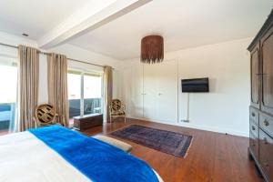 a bedroom with a bed and a large window at Marigold Cascais Villa in Cascais