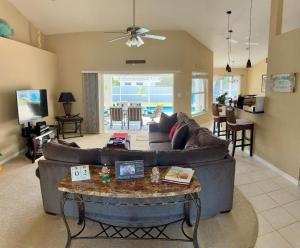 a living room with a couch and a table at VILLA PALM ISLAND in Cape Coral