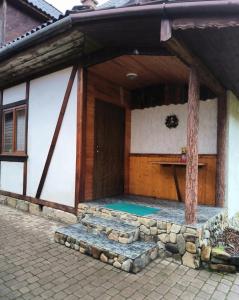 a house with a pool in the front of it at Max hoMe in Tatariv