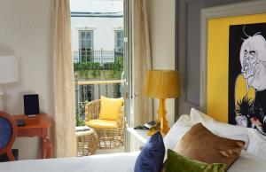 a hotel room with a bed and a balcony at Aria Hotel Budapest by Library Hotel Collection in Budapest