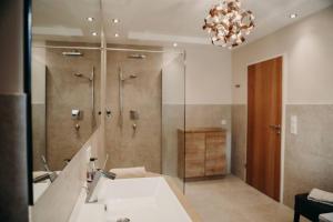 a bathroom with a sink and a shower and a mirror at Apart Veronika Imst - Exklusiv Wohnen in Imst in Imst +34 photos