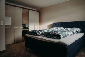 a bedroom with a bed with pillows on it at Apart Veronika Imst - Exklusiv Wohnen in Imst in Imst