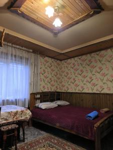 a bedroom with two beds in a room with a window at Max hoMe in Tatariv